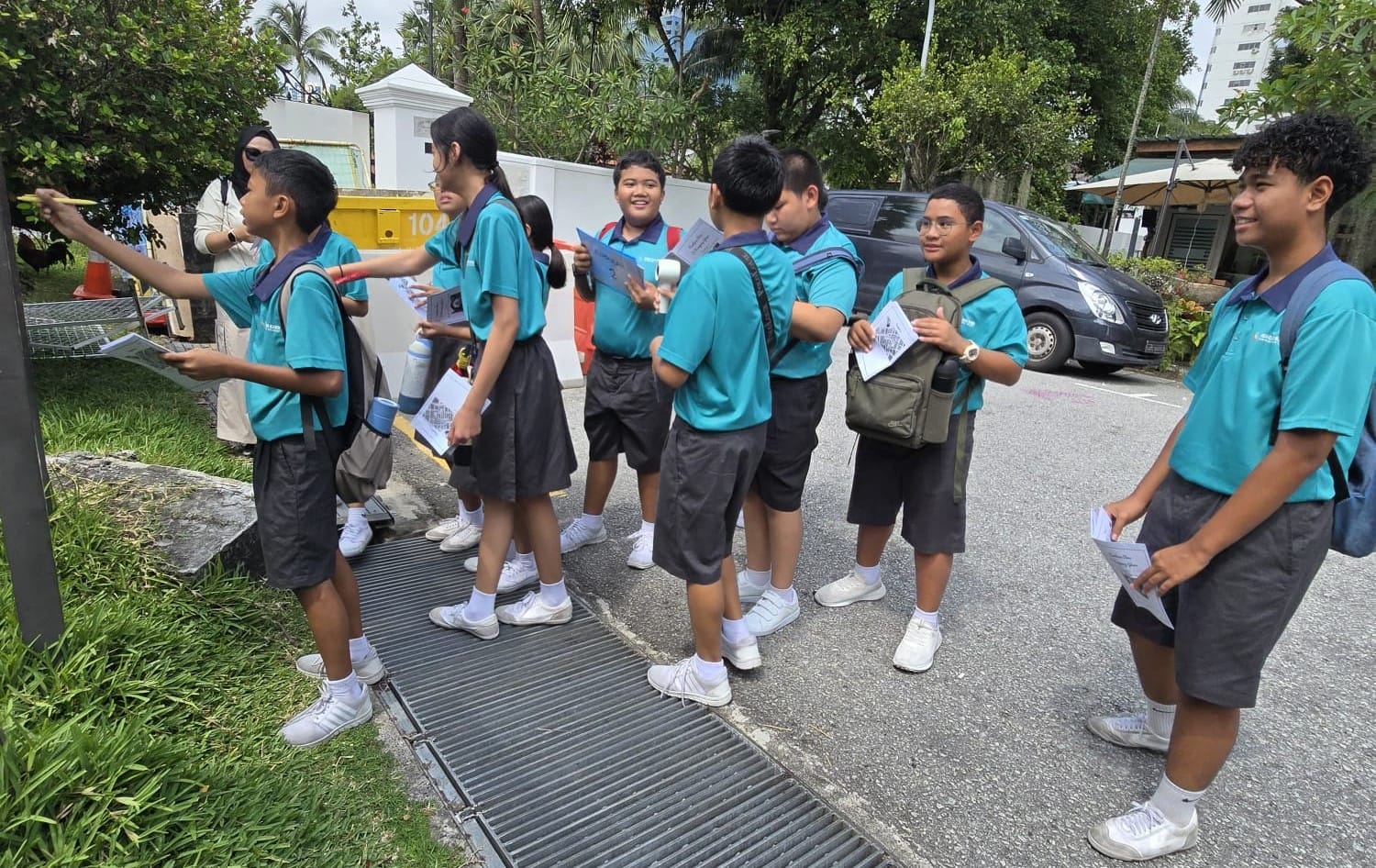 a group of students looking at a sign